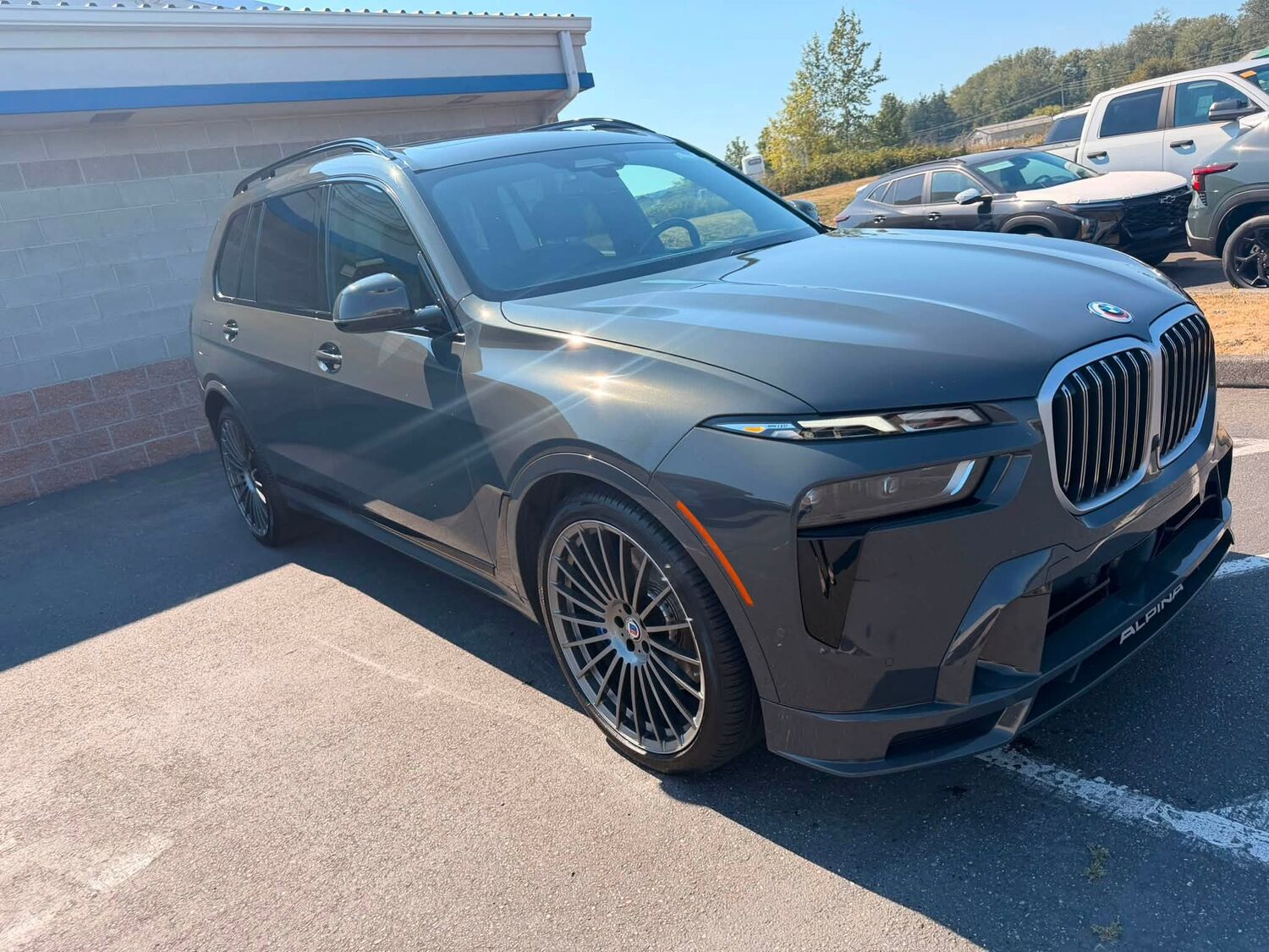 Grey BMW Alpina SUV after an exterior detail, paint and wheels gleaming in the sun