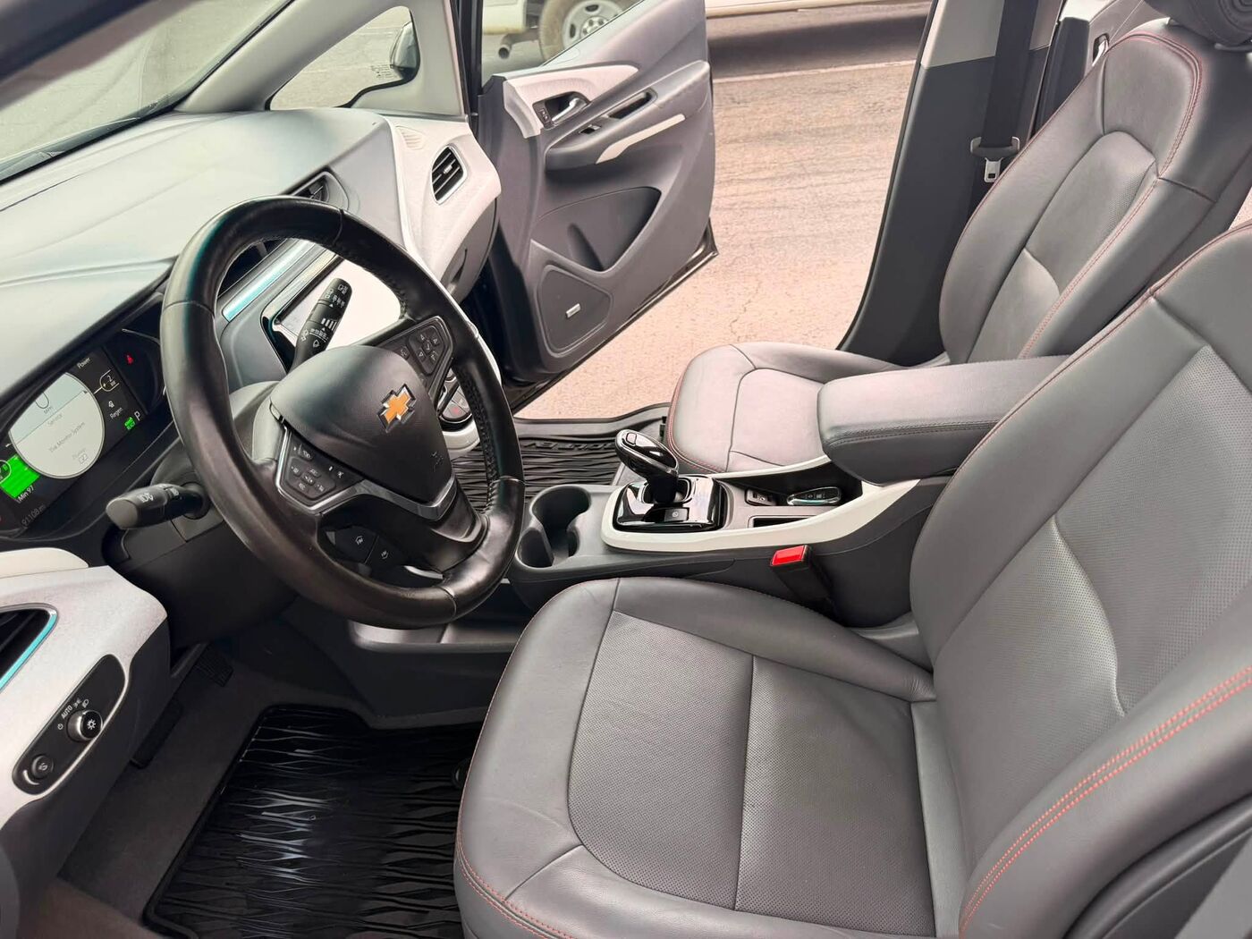 Front seats, console and floor mats of a Chevrolet Bolt after an interior detail