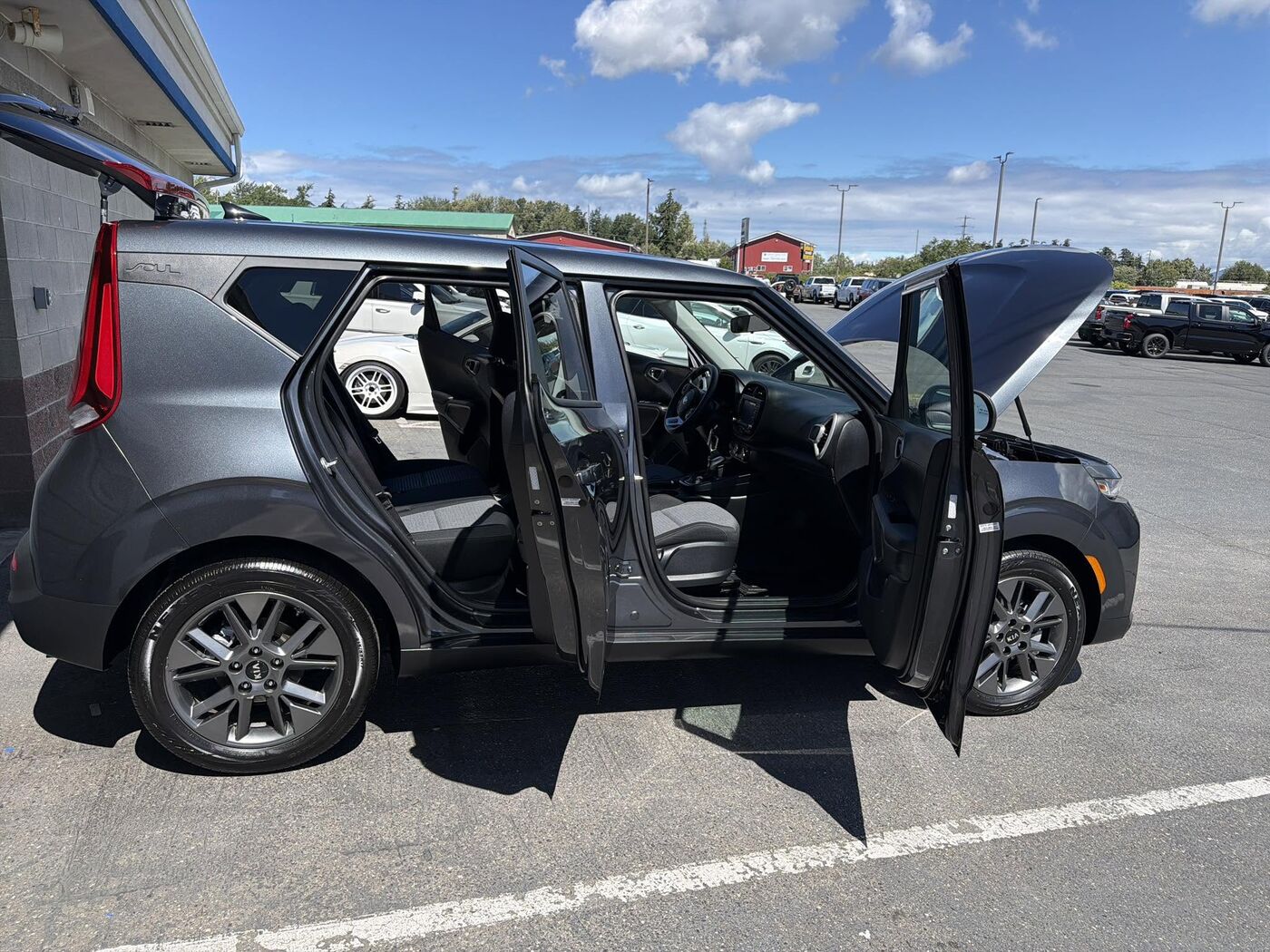 Grey Kia Soul with every door and the hood open after a full detail