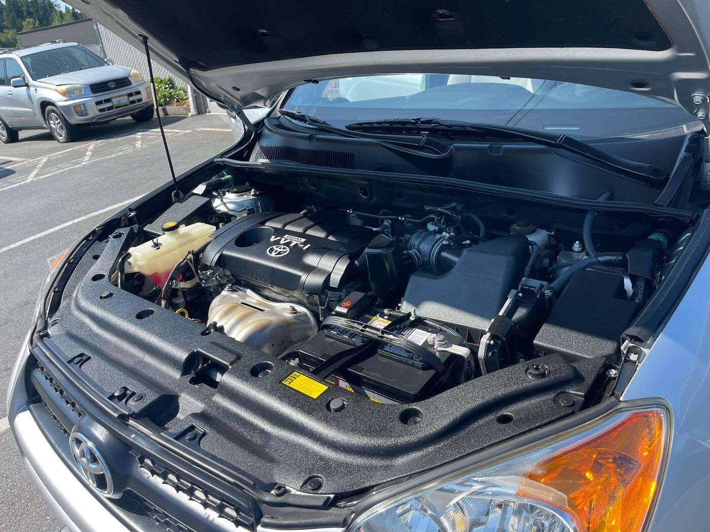 Toyota RAV4 with the hood up showing a cleaned and dressed engine bay