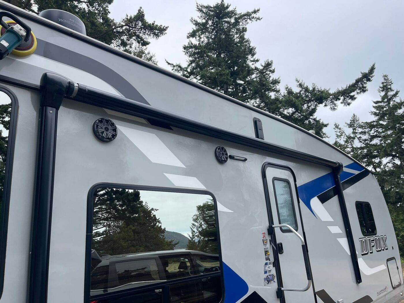 Side of a Desert Fox travel trailer after a wash, graphics bright and clean