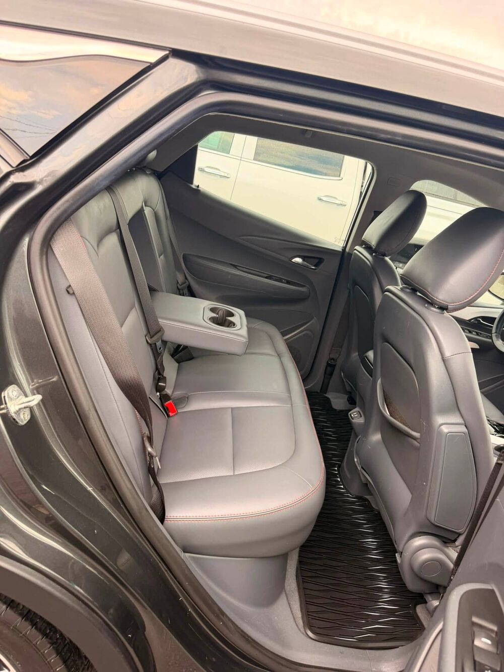 The same back seat after an interior detail, leather clean and floor mats spotless