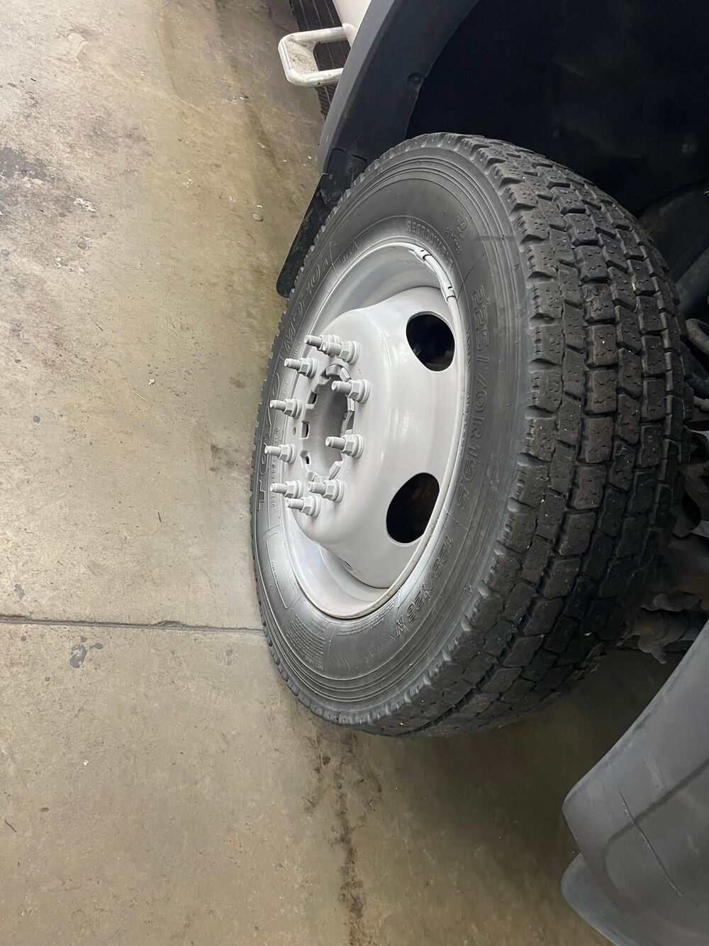 The truck wheel cleaned back to bright white with the tire dressed